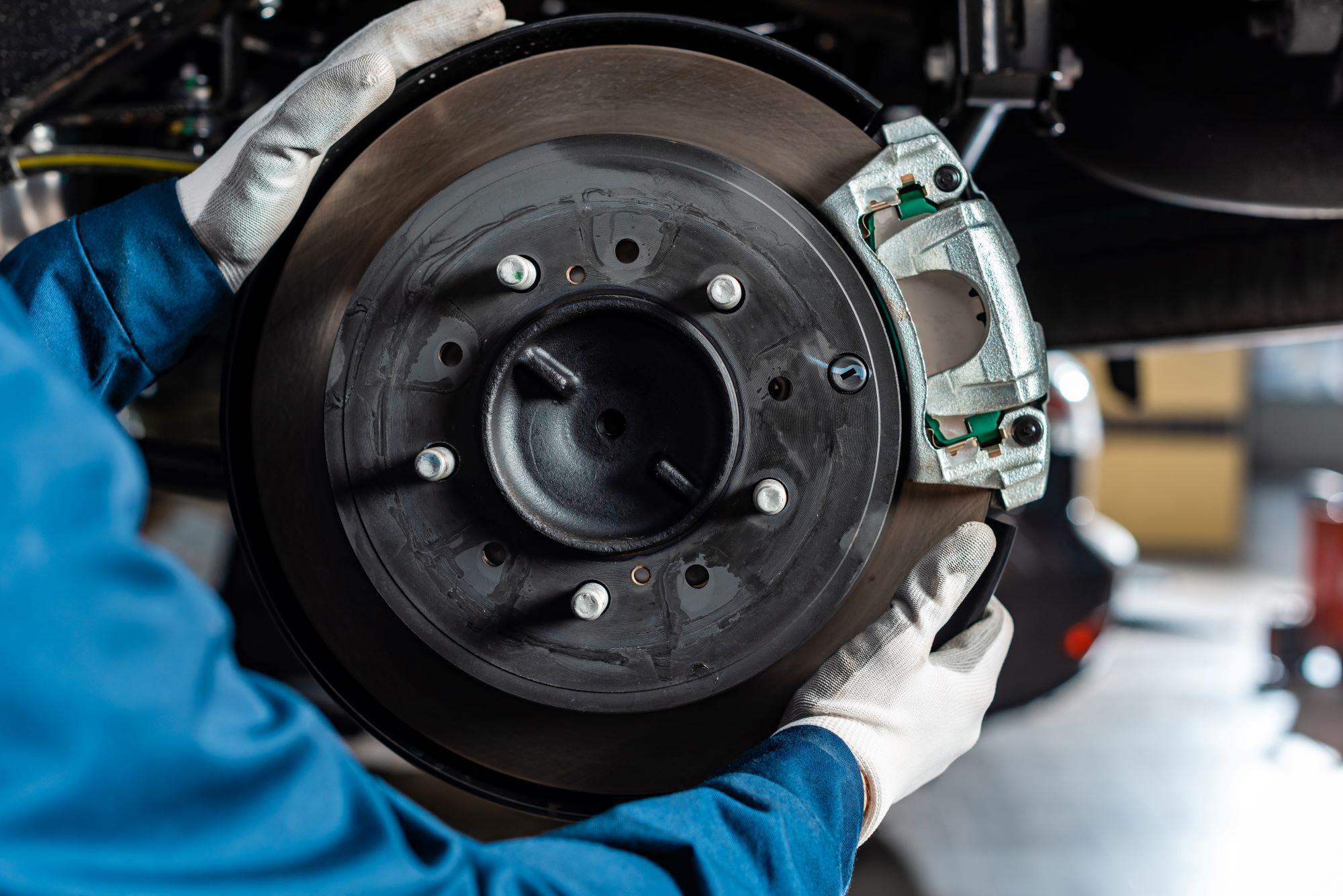 Mechanic inspecting brakes